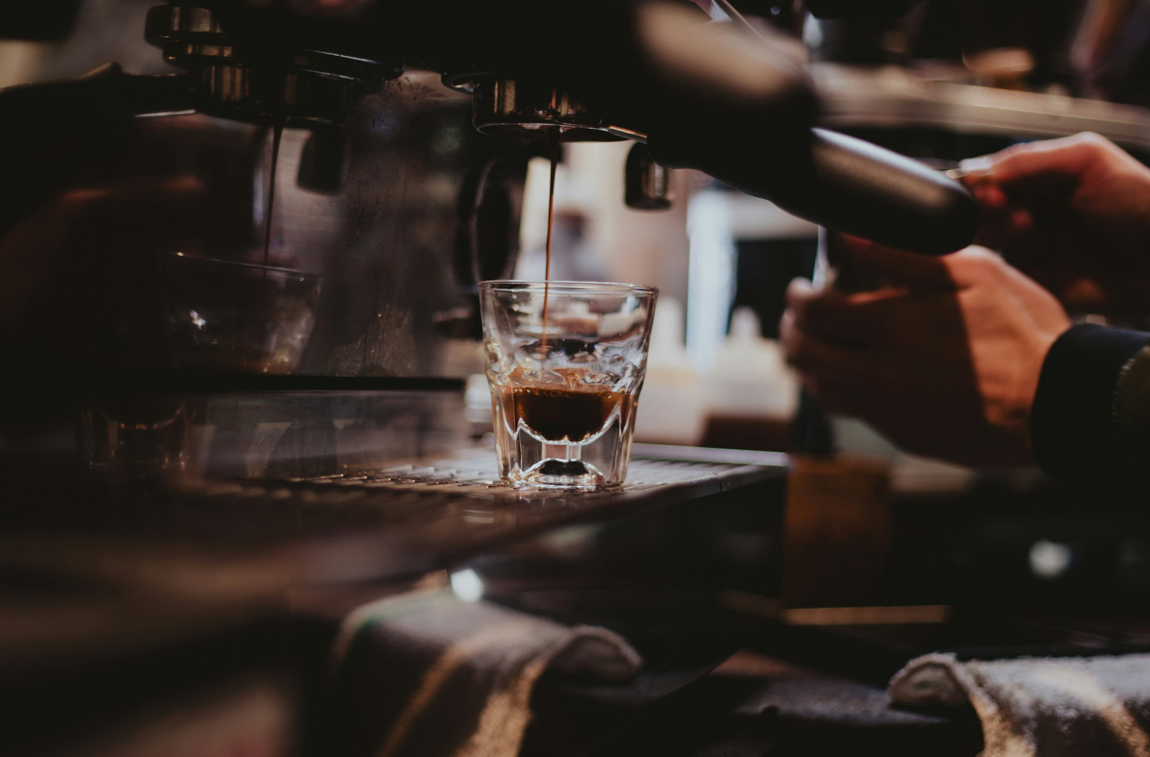 An espresso being prepared at the coffee machine