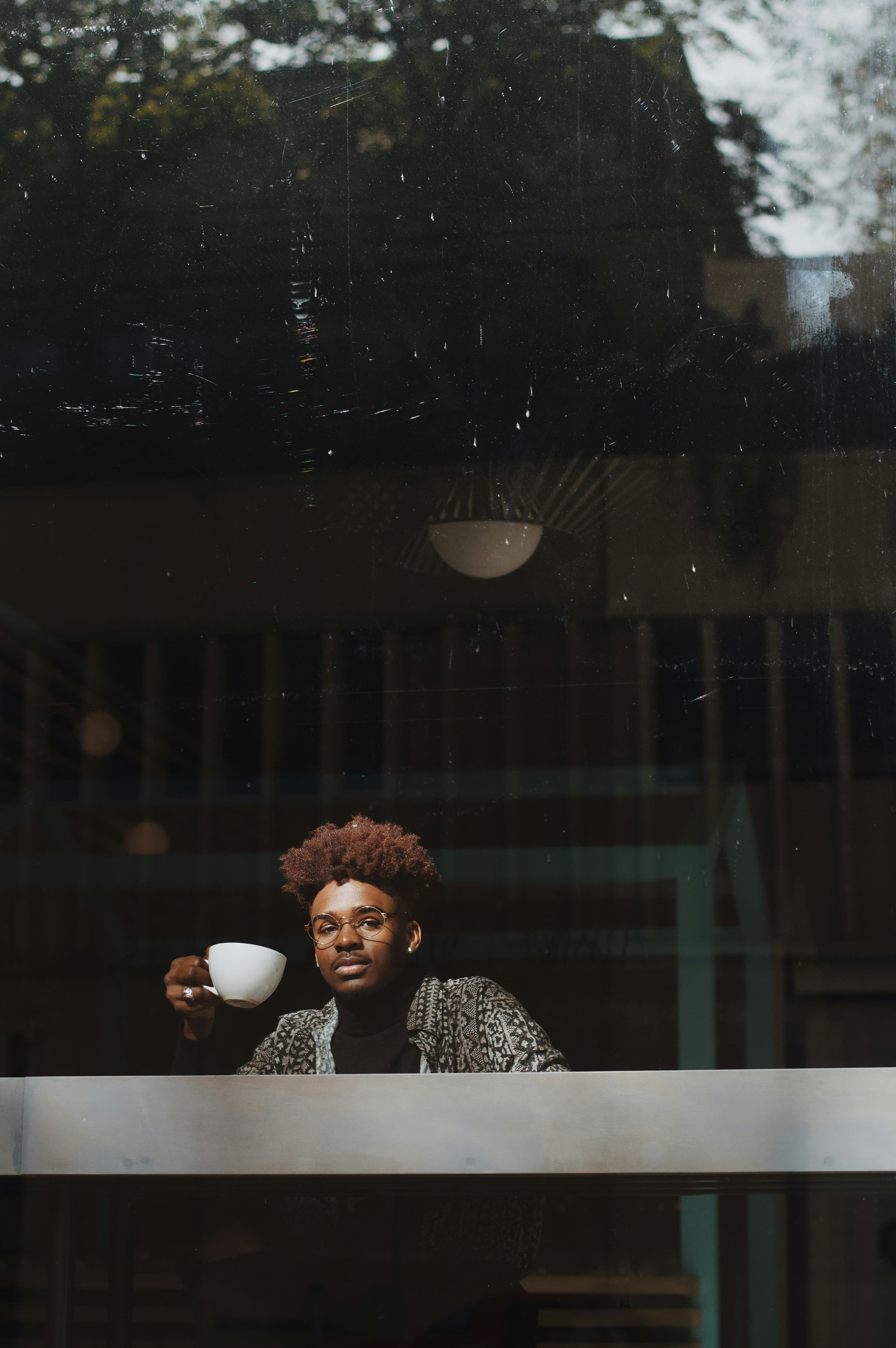 A young man enjoying a cup of coffee