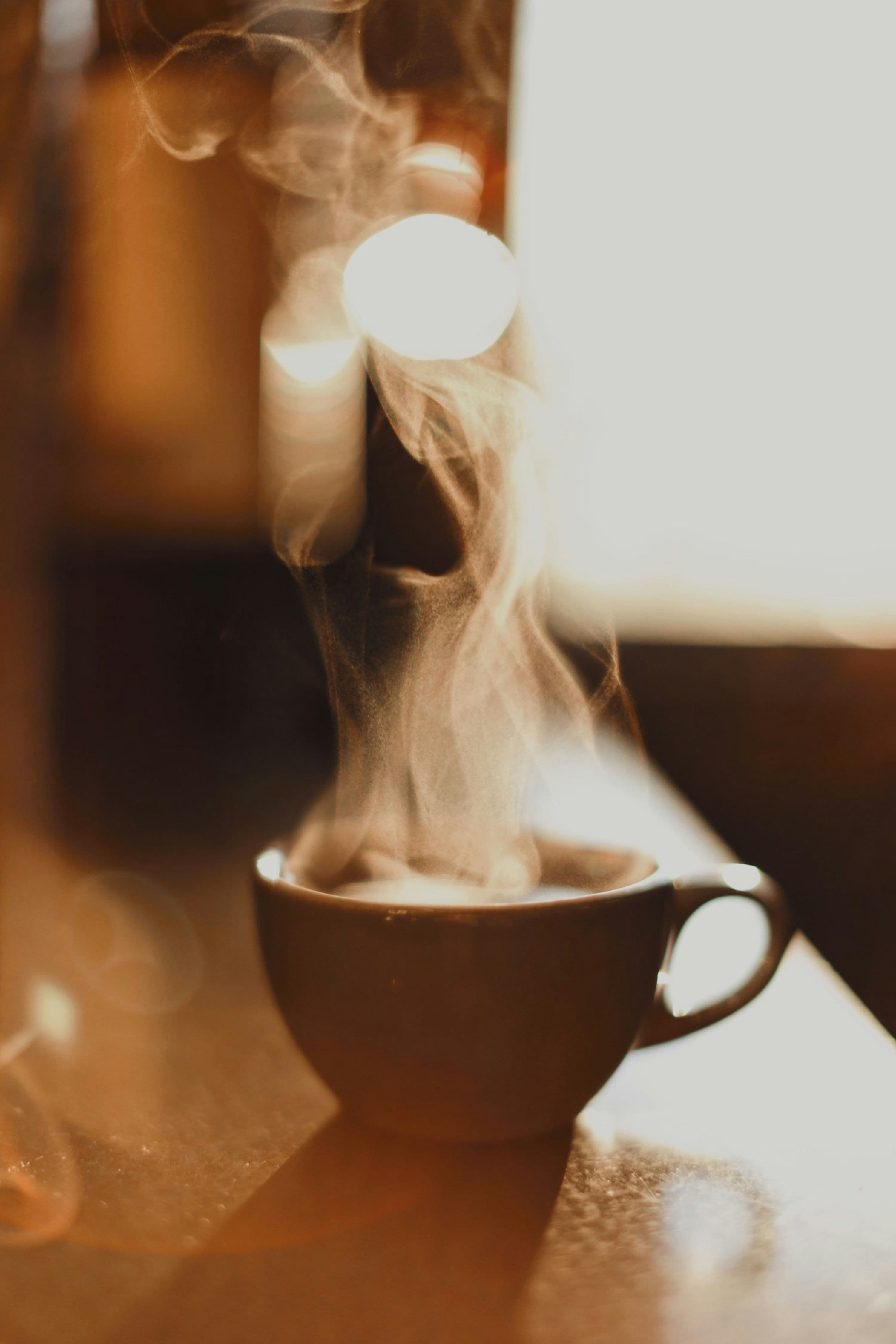 Steam rising from a freshly brewed cup of coffee